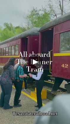 several people are standing near a train that is stopped on the tracks and it says, all aboard the dinner train