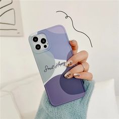 a woman is holding up her phone case