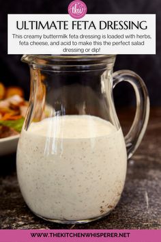 a pitcher filled with white liquid next to a plate of food