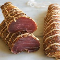 two pieces of meat wrapped in bread on a plate