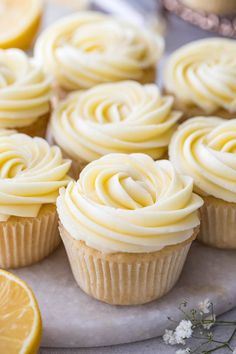 cupcakes with white frosting and lemon slices