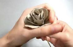 a person holding a paper flower in their hand