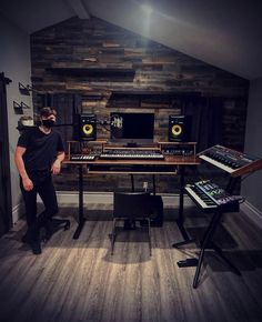 a man standing in front of a desk with sound equipment