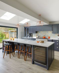 a large kitchen with an island and bar stools