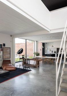 an open living room and dining area with stairs