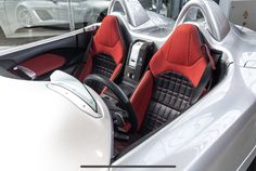 the interior of a sports car with red and black seats