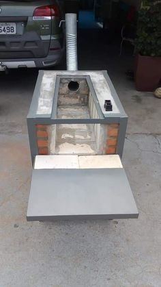 an outdoor grill made out of cement and bricks