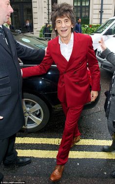 a man in a red suit and white shirt