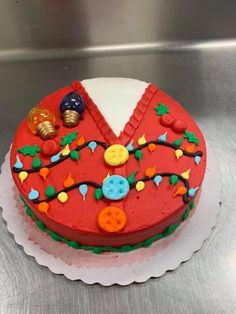 a red cake decorated with buttons and decorations