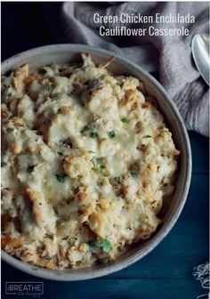 a white bowl filled with chicken enchilada cauliflower casserole