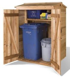 a wooden storage shed with doors open and two trash cans in the bins next to it