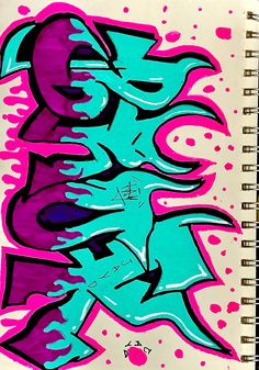 a spiral notebook with blue and pink graffiti on it