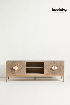 the sideboard is made from wood and has two lights on each side, as well as an open drawer