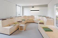 an empty room with benches and tables in it