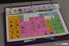 a close up of a board game on a table with clipboards and markers attached to it