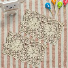 there are two doily on the table next to some lollipops