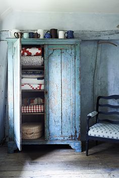 an old blue armoire in a room