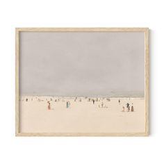 people are standing on the beach in front of an overcast sky, framed in wood