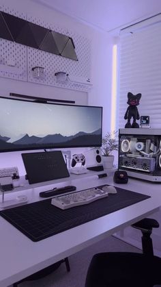 a desk with a computer and speakers on it