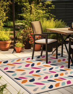 an outdoor area with patio furniture and potted plants on the deck, including table and chairs