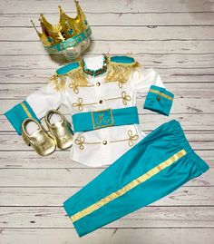 a blue and white outfit with gold trimmings on the collar, pants and shoes