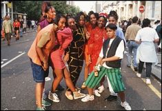 a group of people standing on the side of a road