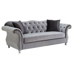 a gray couch with two pillows on it