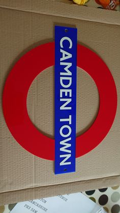 a cardboard box with a sign that says camden town in blue on the front and bottom