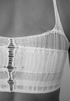 the back of a woman's bra with white crochet and lace on it