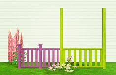 a green and purple fence sitting in the middle of a lush green field next to flowers