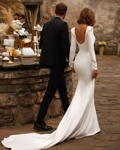 a bride and groom walking away from the reception