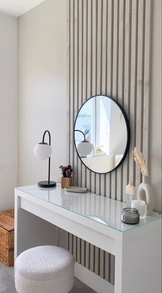 a white desk with a mirror on it and a stool in front of the table