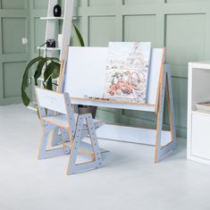 an easel with two chairs next to it