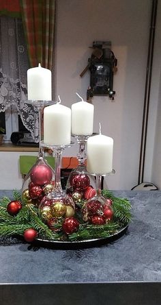 a tray with candles and ornaments on it