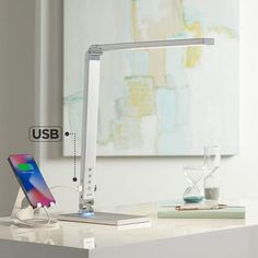 an electronic device is sitting on a desk with the usb dock attached to it's side