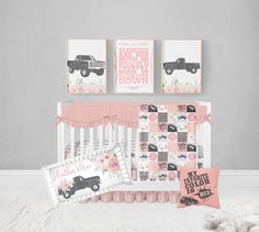 a baby's room with pink and gray decor, including two pictures on the wall