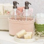 two soap dispensers sitting on top of a shelf next to other items