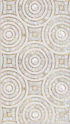 a white and gold rug with circles on it