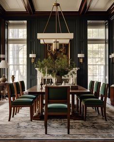 a dining room with green chairs and a chandelier hanging over the wooden table