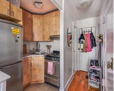 a kitchen with stainless steel appliances and wooden cabinets