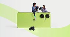 two people sitting on top of a green cell phone with the camera attached to it