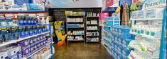 a store filled with lots of different types of water and hygiene products on shelves next to each other