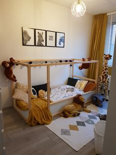 a child's bedroom with stuffed animals on the floor