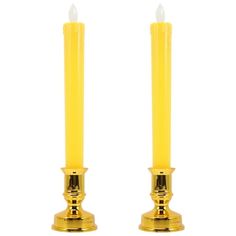 two yellow candles sitting next to each other