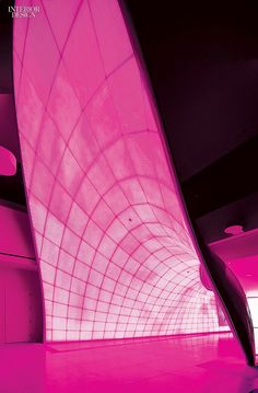 a large pink sculpture is in the middle of a room