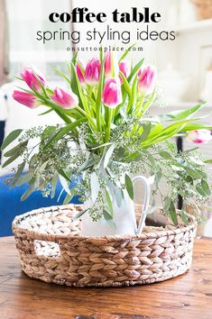 pink tulips and greenery in a basket on a table