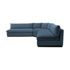 a blue sectional couch sitting on top of a white floor