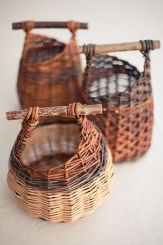 three wicker baskets sitting on top of a white table