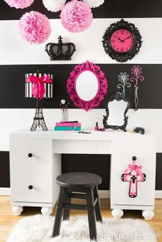 a white desk topped with a mirror and a pink clock mounted to the side of it