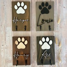 three wooden plaques with dog paw prints on them